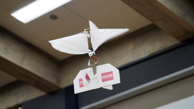 A white flying lightweight robot flies through the air