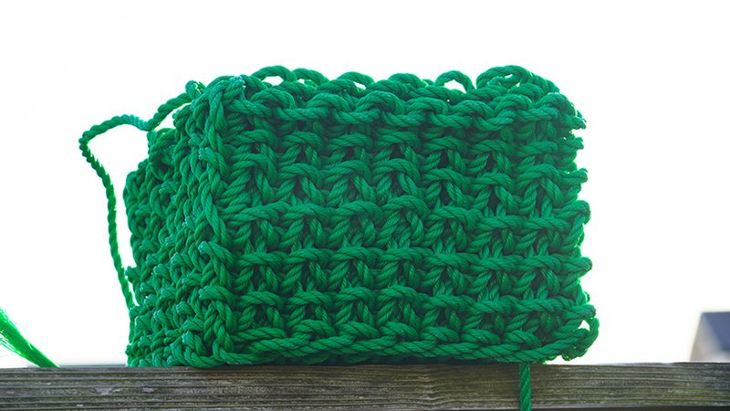 A cube made from green thread - Solid Knitting