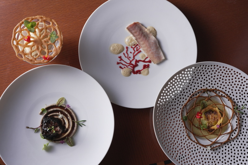 Various dishes garnished with 3D-printed food.